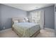 Comfortable bedroom with a bed and large window at 11013 Dundarrach Ln, Charlotte, NC 28277