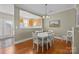 Elegant dining room featuring hardwood floors and an open view into the kitchen at 11013 Dundarrach Ln, Charlotte, NC 28277