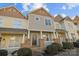 Charming townhome with stone accents, covered porch, and well-maintained landscaping at 11013 Dundarrach Ln, Charlotte, NC 28277