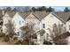 Townhome exterior showcases well-maintained siding, a quaint patio, and fresh landscaping at 11013 Dundarrach Ln, Charlotte, NC 28277