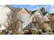 Townhome exterior showcasing well-maintained siding, a quaint patio, and fresh landscaping at 11013 Dundarrach Ln, Charlotte, NC 27277