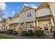 Attractive townhome featuring a covered entrance, stone pillars, and tidy landscaping at 11013 Dundarrach Ln, Charlotte, NC 28277