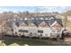 Exterior view of townhomes with well-manicured lawns and mature trees at 11013 Dundarrach Ln, Charlotte, NC 28277