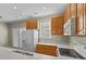 Kitchen featuring wooden cabinets, white appliances, and a stainless steel sink at 11013 Dundarrach Ln, Charlotte, NC 28277