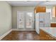 Kitchen corner with tile floors and access to the outdoor patio area at 11013 Dundarrach Ln, Charlotte, NC 28277