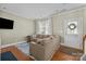 Cozy living room with a comfortable sectional and a view to the front yard at 11013 Dundarrach Ln, Charlotte, NC 28277