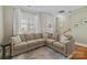 Comfortable living room with a large sectional couch and lots of light at 11013 Dundarrach Ln, Charlotte, NC 28277
