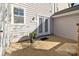 Cozy outdoor patio featuring double doors and charming potted plants at 11013 Dundarrach Ln, Charlotte, NC 28277