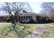 Inviting brick home with a cozy front porch, mature trees, and a well-manicured lawn at 121 Quincy Dr # 1, Belmont, NC 28012