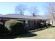 Well-kept brick home with trimmed bushes and a green lawn, showcasing classic curb appeal at 121 Quincy Dr # 1, Belmont, NC 28012