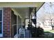 Cozy covered porch featuring classic brick columns and wrought iron details; perfect spot for relaxing at 121 Quincy Dr # 1, Belmont, NC 28012