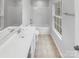 Bright bathroom featuring a shower and tub combo with tile flooring and natural light at 13413 Glasgow Green Ln, Charlotte, NC 28213