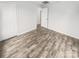 Bedroom featuring wood-look flooring, neutral paint and trim, and access to a walk-in closet at 13413 Glasgow Green Ln, Charlotte, NC 28213