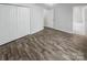 Bedroom with wood-look flooring, neutral paint, and a double door closet at 13413 Glasgow Green Ln, Charlotte, NC 28213