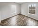 Bright bedroom with wood-look flooring and two windows offering natural light and neighborhood views at 13413 Glasgow Green Ln, Charlotte, NC 28213