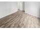 Bedroom featuring wood floors, white walls and trim, with entry to closet and bath at 13413 Glasgow Green Ln, Charlotte, NC 28213