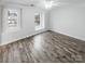 Bedroom with wood-look flooring, large windows, and a ceiling fan at 13413 Glasgow Green Ln, Charlotte, NC 28213