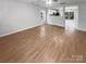 Spacious living room featuring wood-look flooring and views into the kitchen at 13413 Glasgow Green Ln, Charlotte, NC 28213