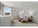 Bright Bedroom with neutral tones, a crib, and patterned wallpaper creates a comforting and stylish haven at 14061 Lake Home Ln, Charlotte, NC 28278