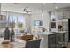 Open living room featuring a central kitchen island and large windows providing ample natural light at 14061 Lake Home Ln, Charlotte, NC 28278