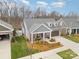 Charming home with manicured lawn, mulch beds, and a private driveway at 15103 Honeycutt Dr, Huntersville, NC 28078