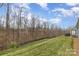 Expansive backyard featuring a black fence with views of a wooded area at 15103 Honeycutt Dr, Huntersville, NC 28078