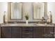 Bathroom featuring dual sinks, granite countertops, and dark wood cabinets, creating a spa-like experience at 15103 Honeycutt Dr, Huntersville, NC 28078