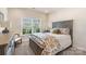 Comfortable bedroom with a large window, a cozy bed, and ample natural light creating a welcoming space at 15103 Honeycutt Dr, Huntersville, NC 28078