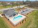 Community pool featuring a fenced area, ample parking, and manicured landscaping at 15103 Honeycutt Dr, Huntersville, NC 28078