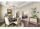 A dining room featuring a round table, modern chandelier, and views into the adjacent living space at 15103 Honeycutt Dr, Huntersville, NC 28078