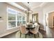 Bright dining room with a modern chandelier and a large window overlooking the outdoor patio at 15103 Honeycutt Dr, Huntersville, NC 28078