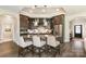 Open kitchen boasts dark cabinetry, granite countertops, stainless steel appliances, and a breakfast bar with seating at 15103 Honeycutt Dr, Huntersville, NC 28078