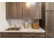 Functional laundry area with ample cabinet storage, modern sink and neutral-toned countertops at 15103 Honeycutt Dr, Huntersville, NC 28078