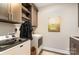 Well-equipped laundry room featuring modern appliances, stylish cabinets and functional shelving at 15103 Honeycutt Dr, Huntersville, NC 28078