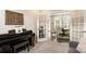 Cozy living room leading to dining area, with piano, french doors and modern lighting at 15103 Honeycutt Dr, Huntersville, NC 28078