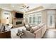 Bright living room showcasing a stone fireplace, large window, comfortable sofa, and contemporary decor at 15103 Honeycutt Dr, Huntersville, NC 28078