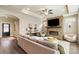 Cozy living room with a stone fireplace, comfortable seating, recessed lighting, and hardwood floors at 15103 Honeycutt Dr, Huntersville, NC 28078