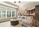 Open-concept living space with a large window, comfortable sofa, and seamless flow into the kitchen at 15103 Honeycutt Dr, Huntersville, NC 28078