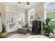 Cozy sunroom with comfortable seating, bright natural light, and access to outdoor space at 15103 Honeycutt Dr, Huntersville, NC 28078