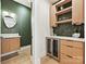 An elegant bar area complements a nearby bathroom with a sink and mirror at 1516 N Caldwell St, Charlotte, NC 28206
