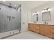 Modern bathroom boasts dual vanities, a glass enclosed shower with a rainfall showerhead at 1516 N Caldwell St, Charlotte, NC 28206