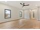 Bright bedroom with hardwood floors, a modern ceiling fan, and ensuite bathroom access at 1516 N Caldwell St, Charlotte, NC 28206
