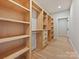 Walk-in closet has custom shelving, drawers, and hardwood floors for organized storage at 1516 N Caldwell St, Charlotte, NC 28206