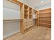 Walk-in closet has custom shelving, drawers, and hardwood floors for ample storage at 1516 N Caldwell St, Charlotte, NC 28206