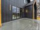 Deck boasts sleek black siding, modern lighting, and sliding glass doors for indoor/outdoor living at 1516 N Caldwell St, Charlotte, NC 28206