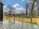 Outdoor deck showcases a wooden fence and rod iron railing, overlooking the backyard at 1516 N Caldwell St, Charlotte, NC 28206