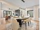 Elegant dining room with modern lighting, an open floor plan, hardwood floors, and views of the living area at 1516 N Caldwell St, Charlotte, NC 28206
