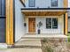 Close up of the modern front porch with its sleek door and bright modern accents at 1516 N Caldwell St, Charlotte, NC 28206
