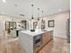 Modern kitchen with a waterfall island, stainless steel appliances, and open layout to the dining and living areas at 1516 N Caldwell St, Charlotte, NC 28206
