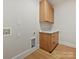 Laundry room with built-in storage and granite countertop provides a functional space at 1516 N Caldwell St, Charlotte, NC 28206